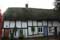 Row of houses in timber framing under thatched roof